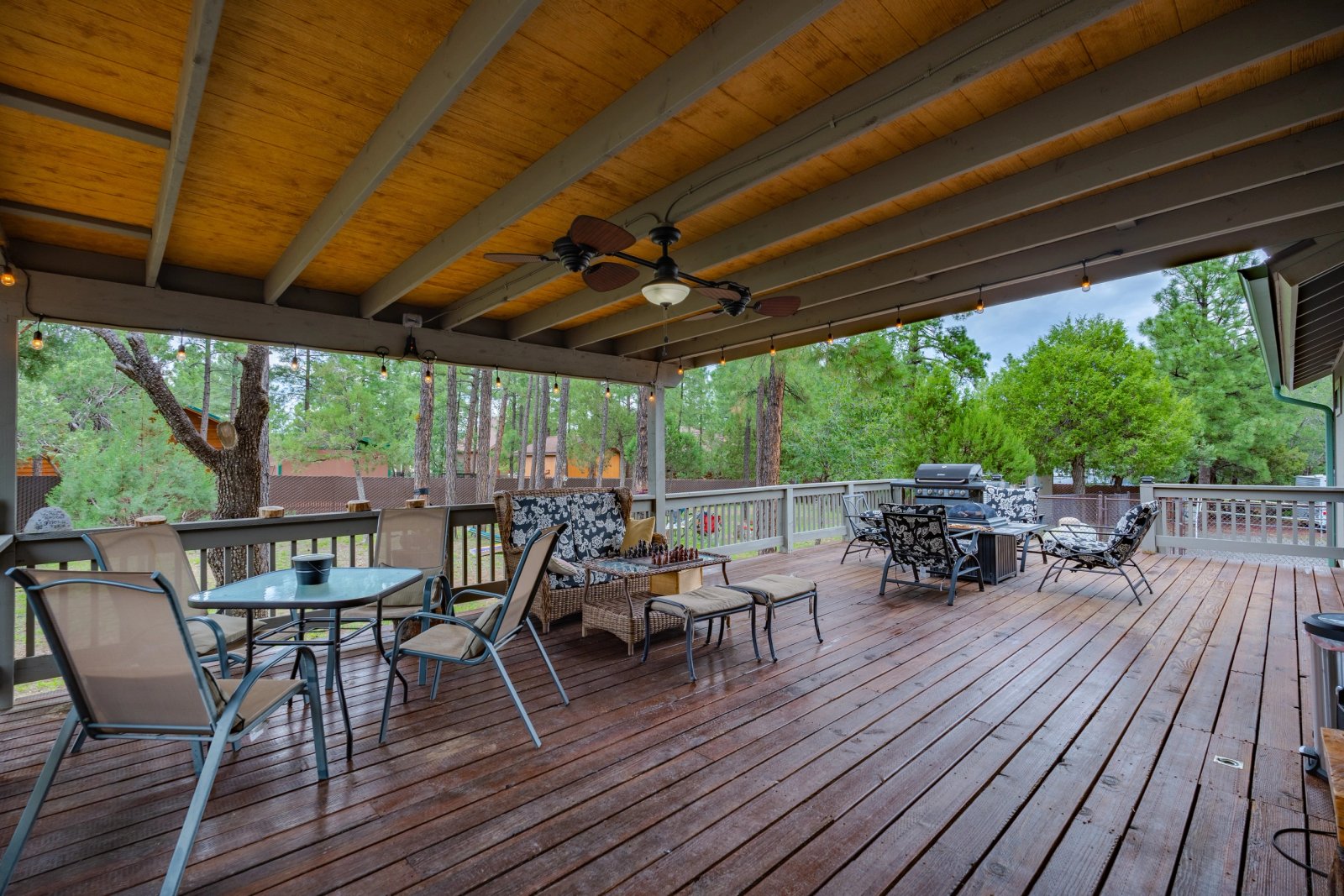 Covered deck with pine views at our three-bedroom Lakeside AZ cabin near Rainbow Lake